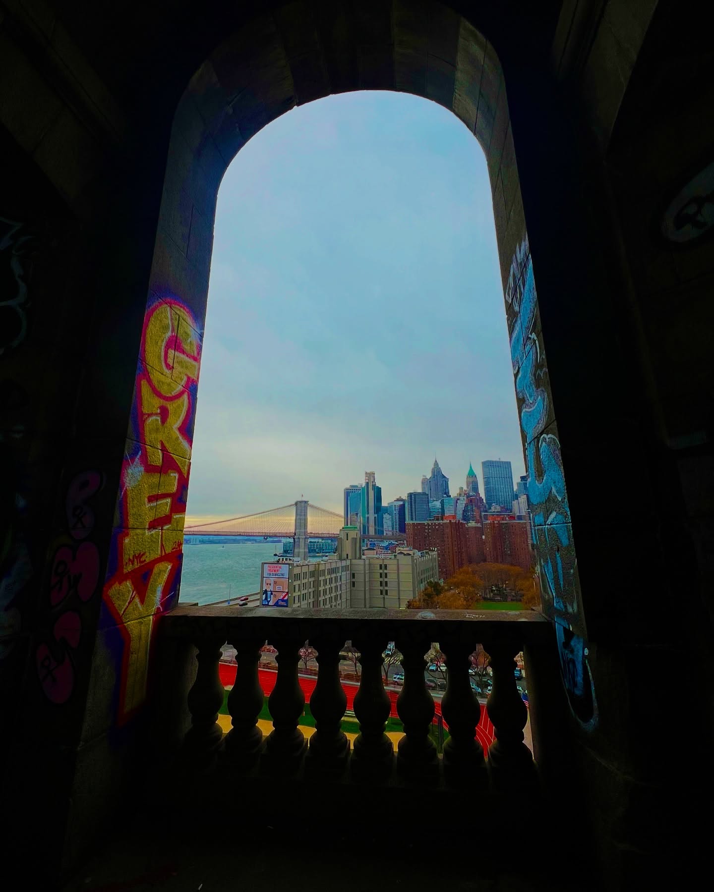 Lower Manhattan seen through an arched DUMBO viewpoint